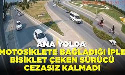 Ana yolda motosiklete bağladığı iple bisiklet çeken sürücü cezasız kalmadı