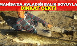 Manisa'da kendi boyunda balık yakaladı